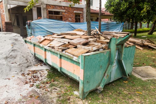 Construction workers removing debris from a building site in Neasden